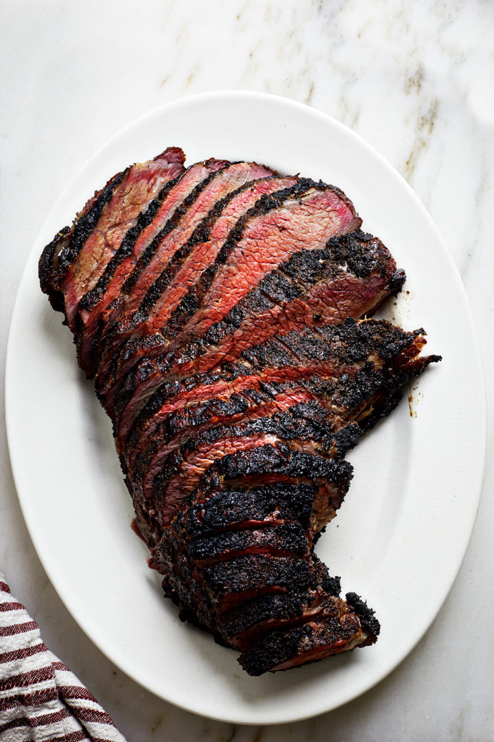 sliced smoke santa maria tri tip on a white platter before serving