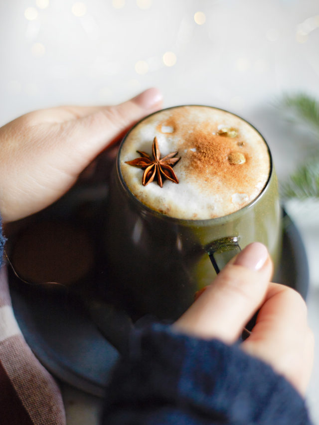 woman holding a mug of gingerbread chai latte