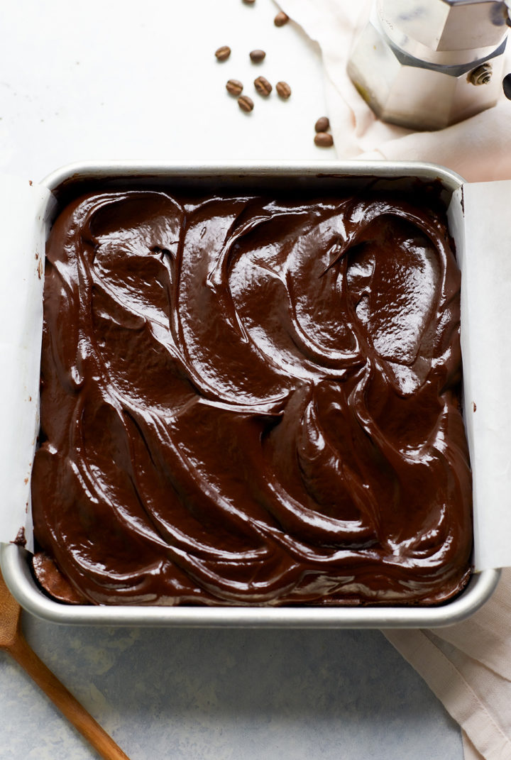 espresso brownies topped with chocolate ganache in a baking pan