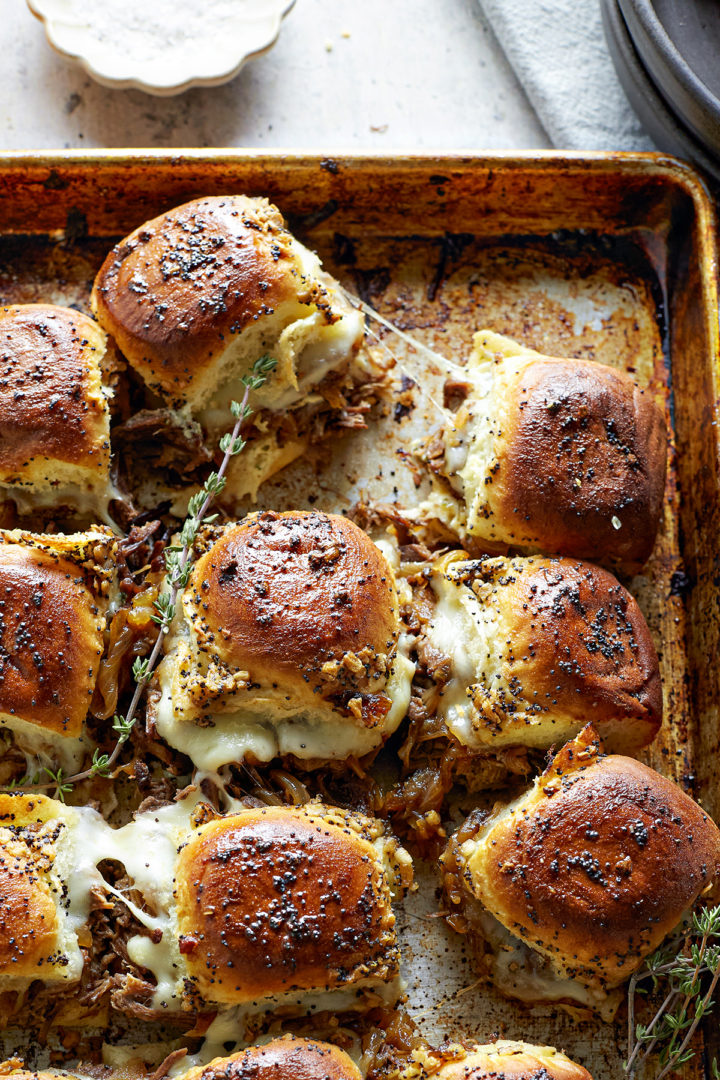 french dip sliders on a baking sheet