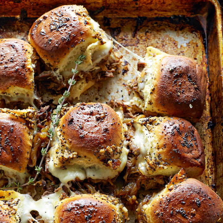 french dip sliders on a baking sheet