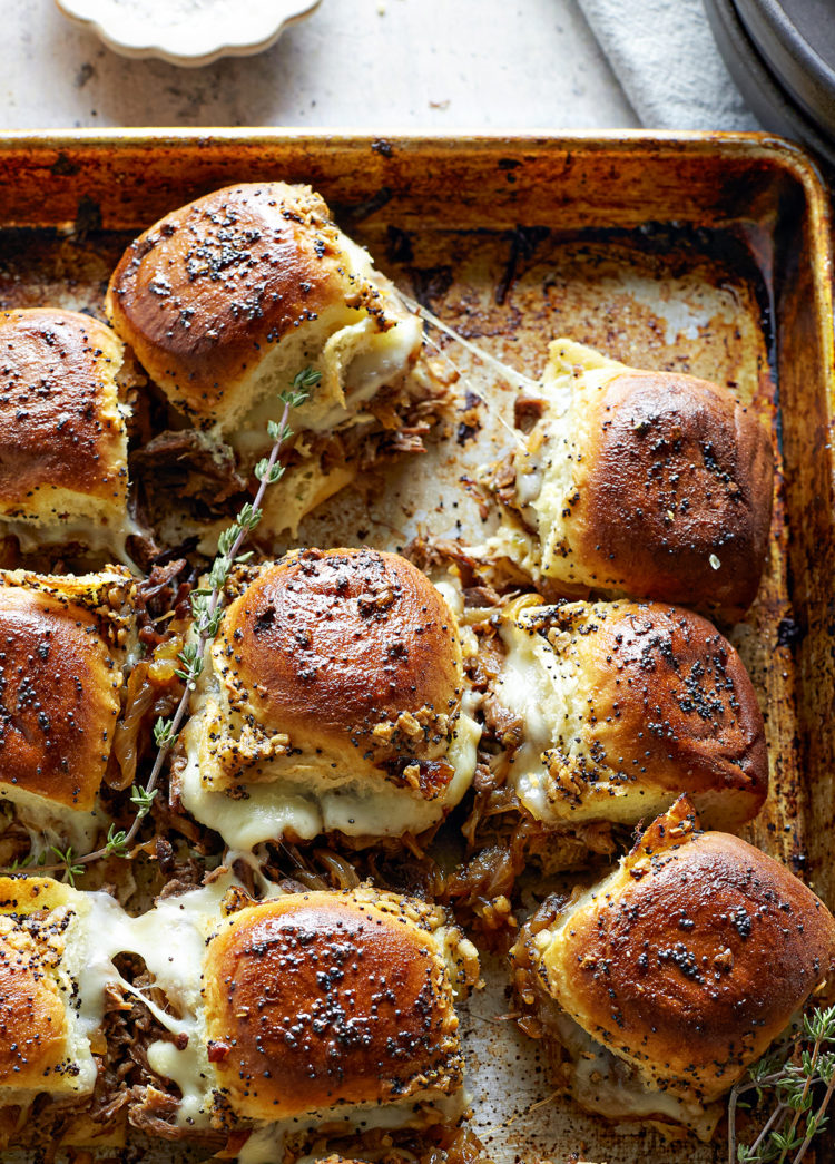 french dip sliders on a baking sheet