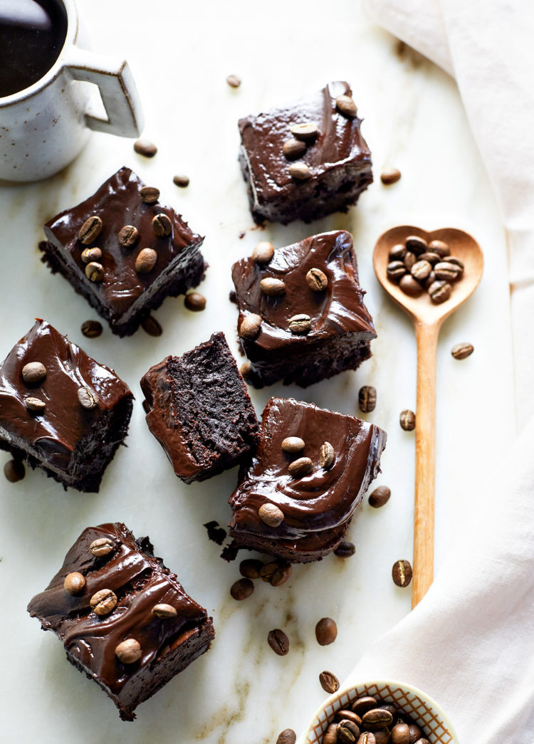 squares of espresso brownies topped with espresso beans on a marble counter